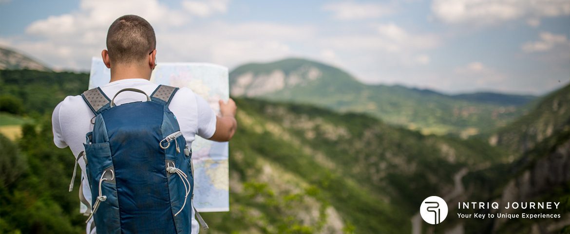 Traveller holding a map facing a scenery